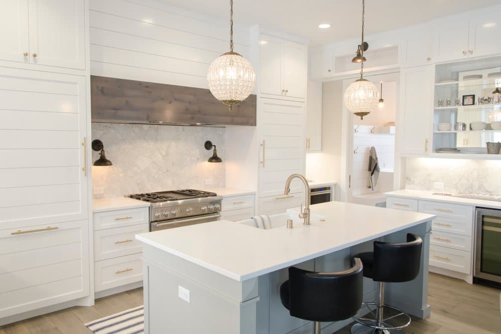 White kitchen with island bench and pendant lights